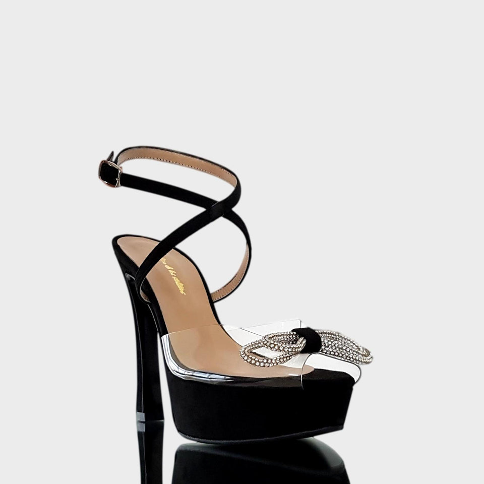 La chica de los stilettos Sandalias Georgia Black en Gamuza Negra y PVC Transparente con Aplique de Strass en Forma de Moño. Presenta un Taco de 12 cm y una Plataforma de 3.5 cm. Vista de Frente y Lateral