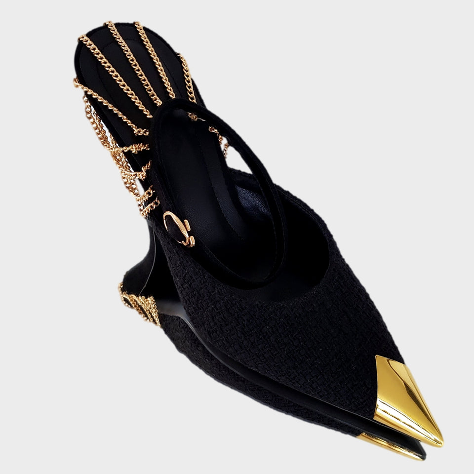 La chica de los stilettos Stilettos Kelly Black en Bouclé Negro, con Detalle de Cadenas de Metal Oro en el Talón, Puntera en Metal Oro, y Taco en Gamuza Negra de 10 cm. Vista Frontal